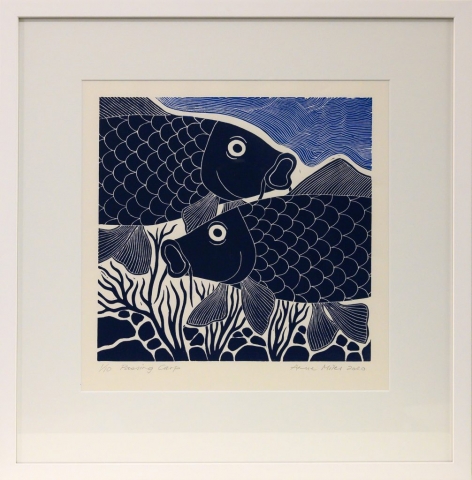 Framed artwork by Anne Miles of 2 dark blue Carp with rocks and weeds and lighter blue swirly water