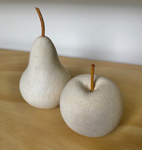 Limestone life size apple and pear sculptures with applewood stems.