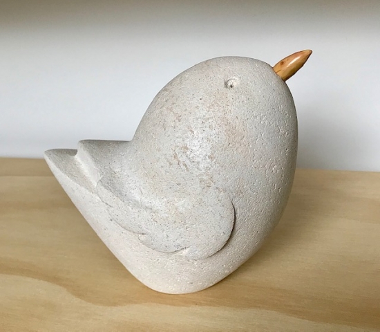 Limestone bird sculpture with applewood beak