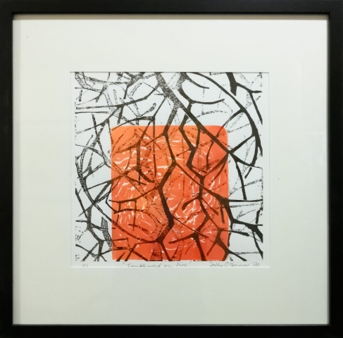 Framed artwork by Sally OConnor of layers of closeup black tumbleweed branches on a orange/red background