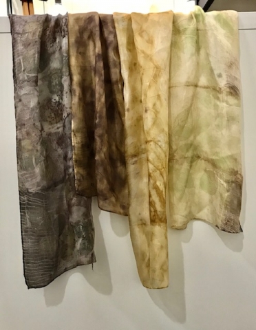 Silk scarves in varying brown shades using natural dyes.